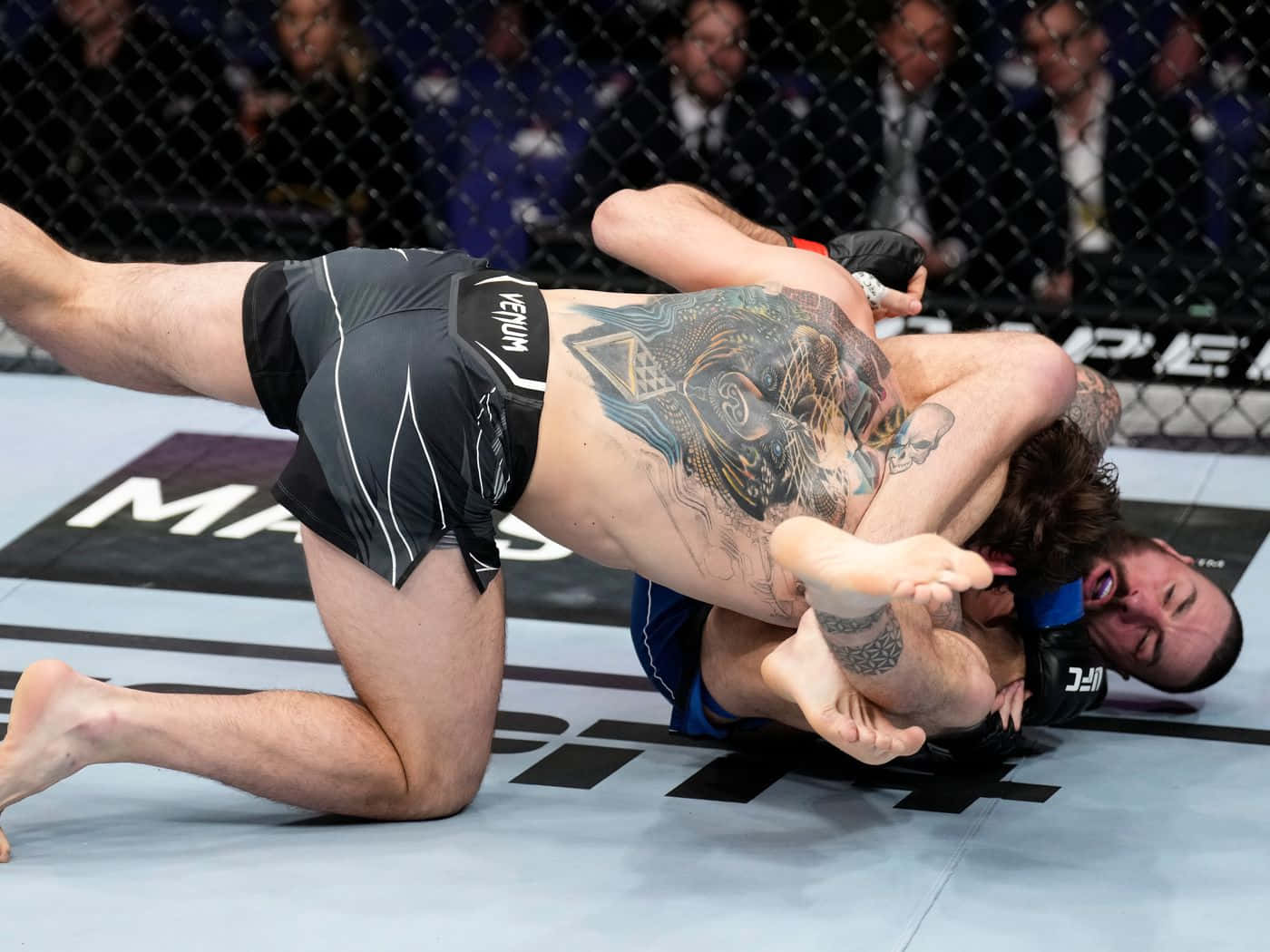 Nikita Krylov Skillfully Escapes Headlock From An Opponent In A High-stakes Match Background