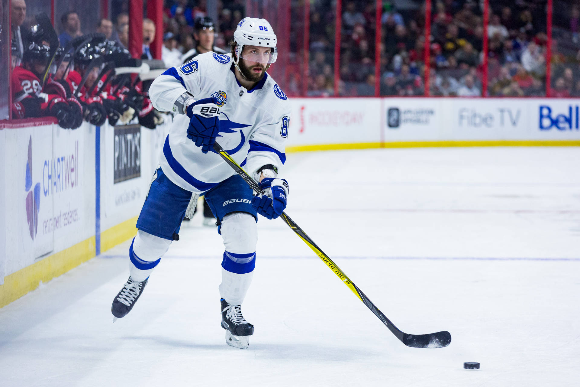 Nikita Kucherov - A Dynamic Right Winger On Ice Background