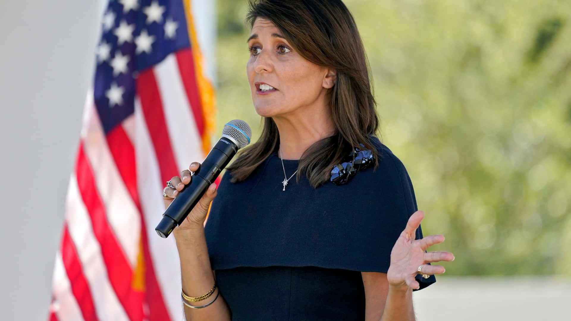 Nikki Haley Delivering A Speech Holding A Microphone Background