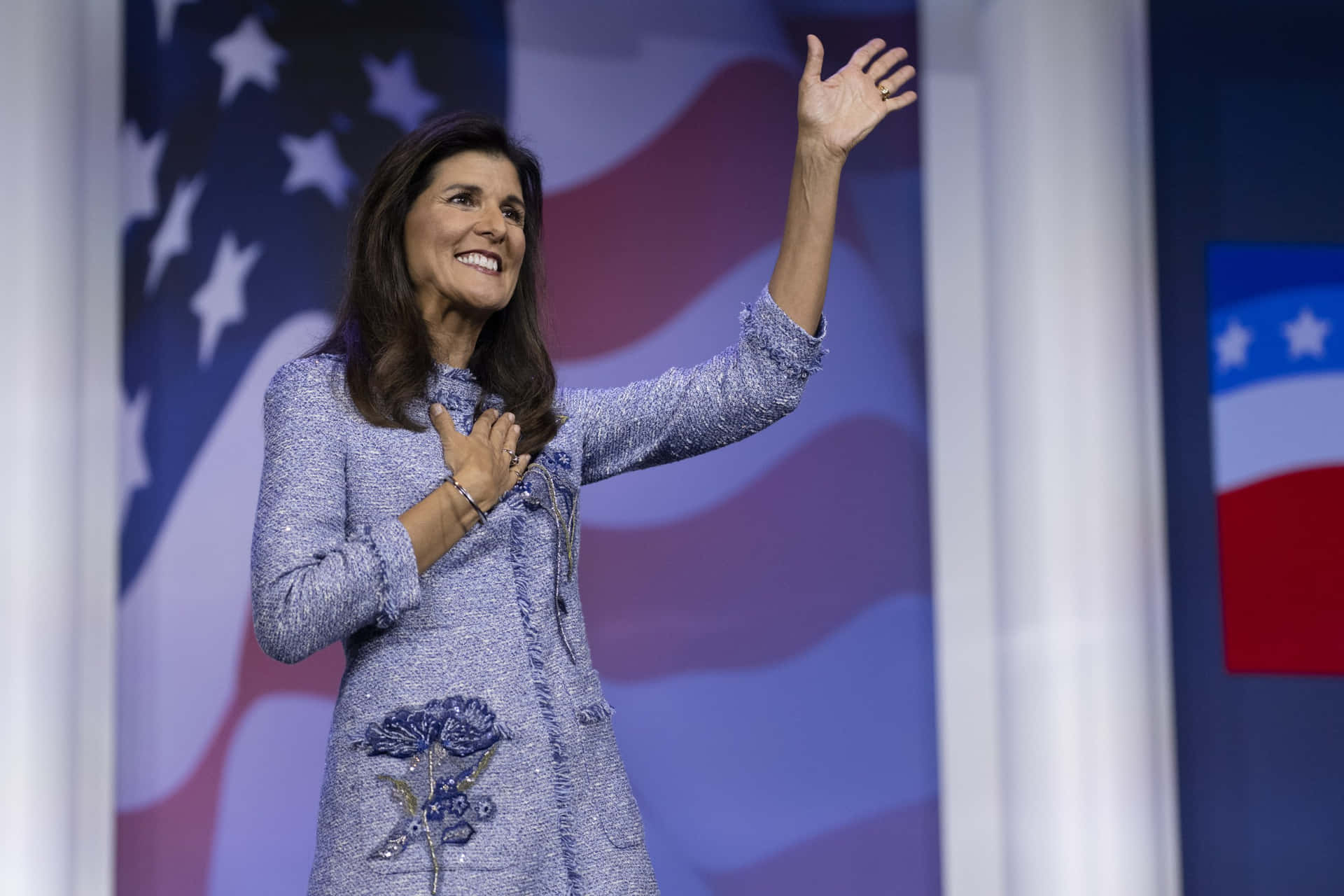 Nikki Haley Raising Her Hand In Determined Gesture Background
