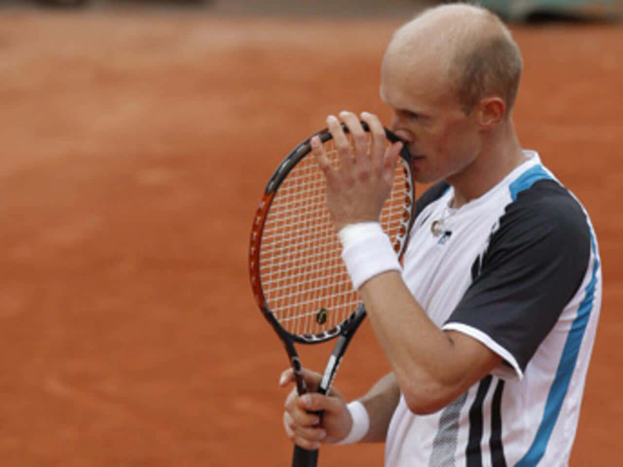 Nikolay Davydenko Pondering Tactics On The Tennis Court Background