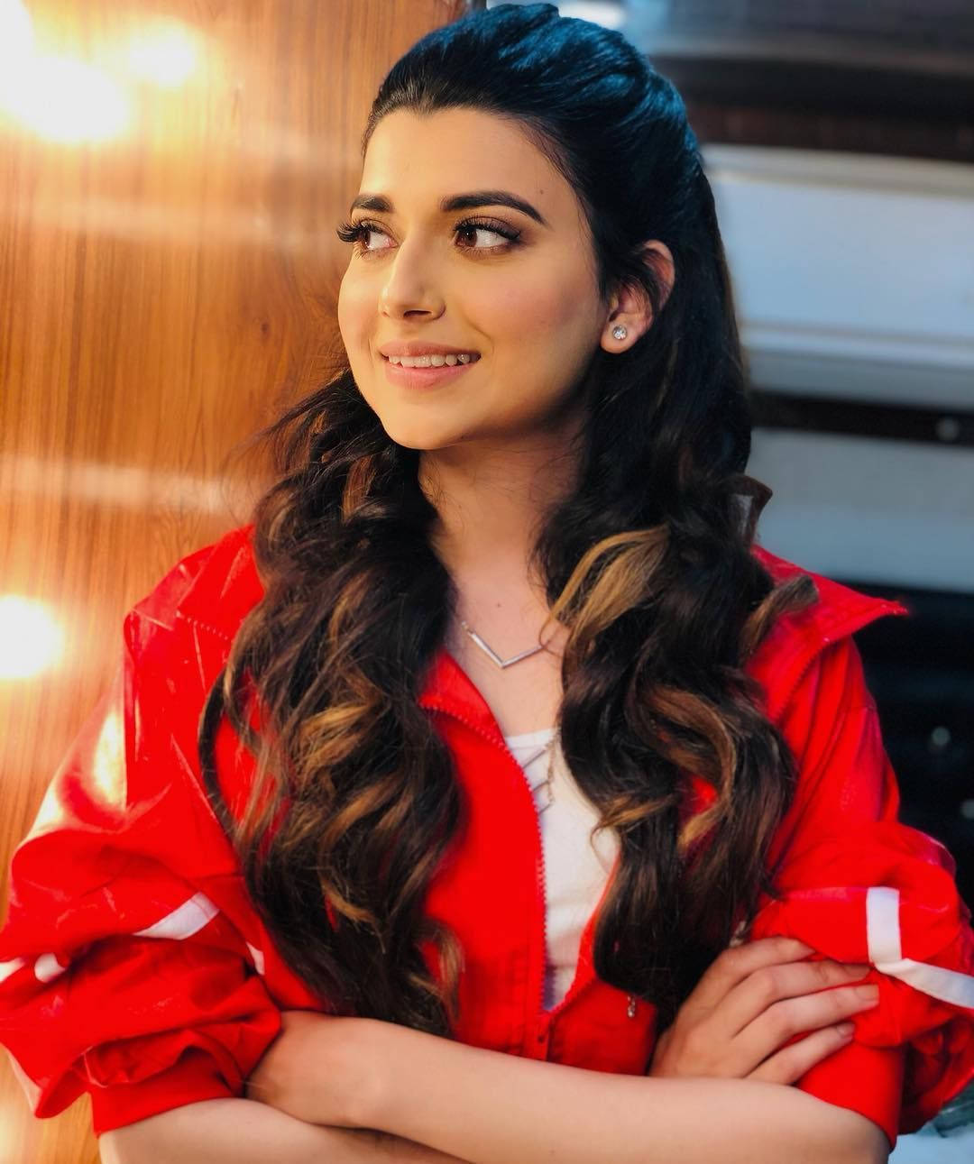 Nimrat Khaira Crossed Arms Background