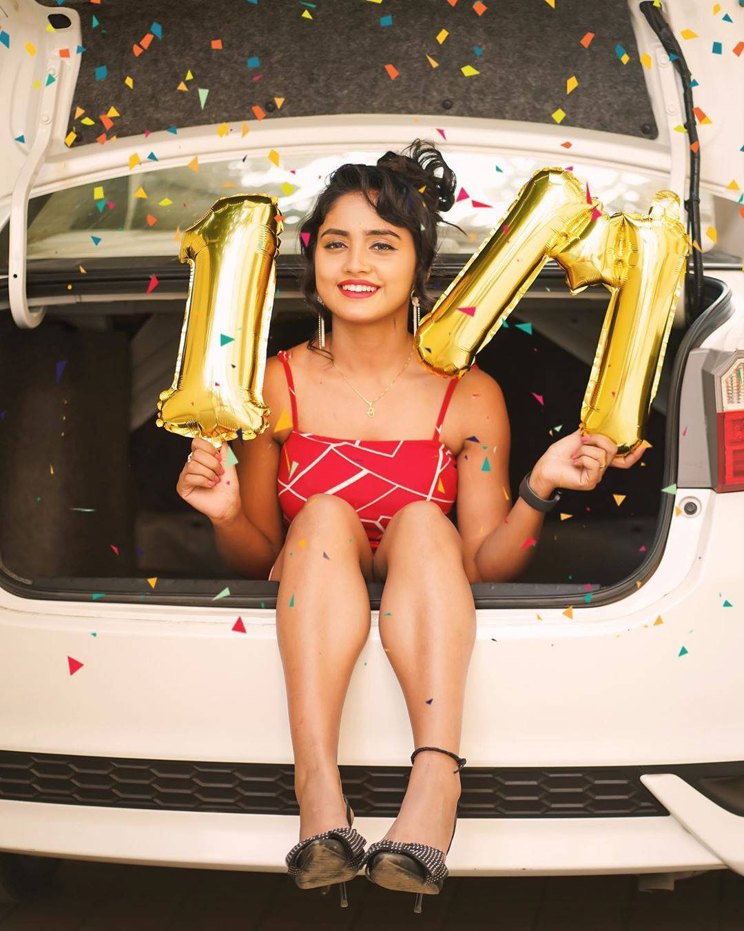 Nisha Guragain Holding Gold Balloons Background