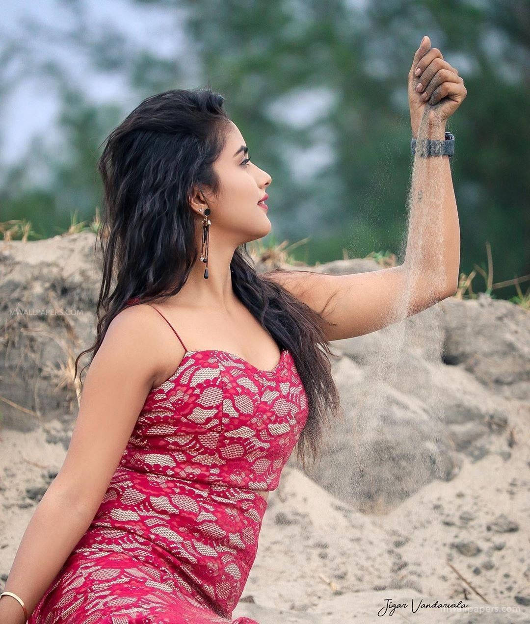 Nisha Guragain Holding Sand Background