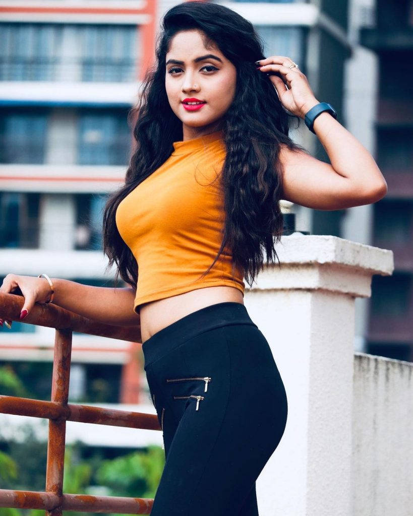 Nisha Guragain In Orange Top Background