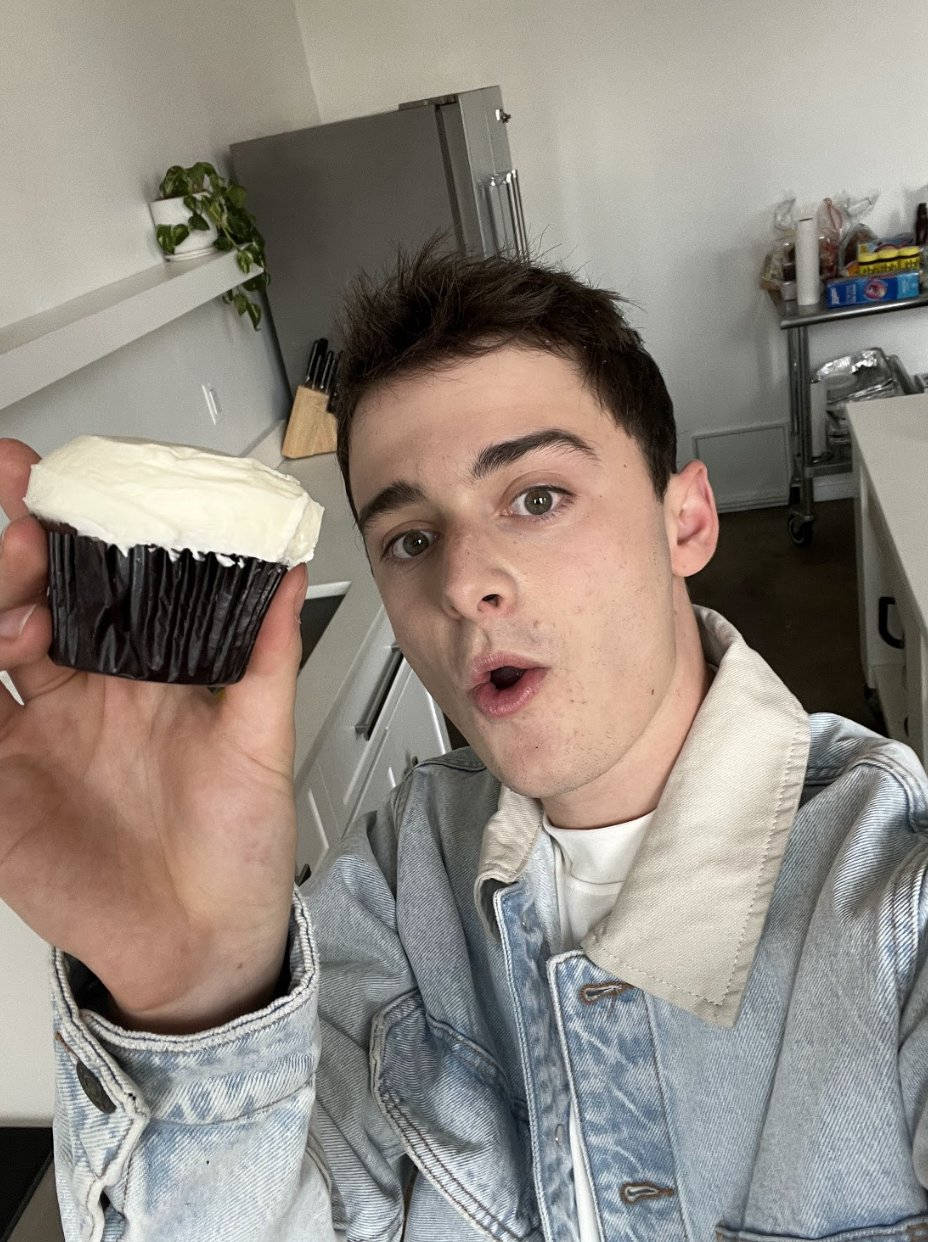 Noah Schnapp Holding A Cupcake