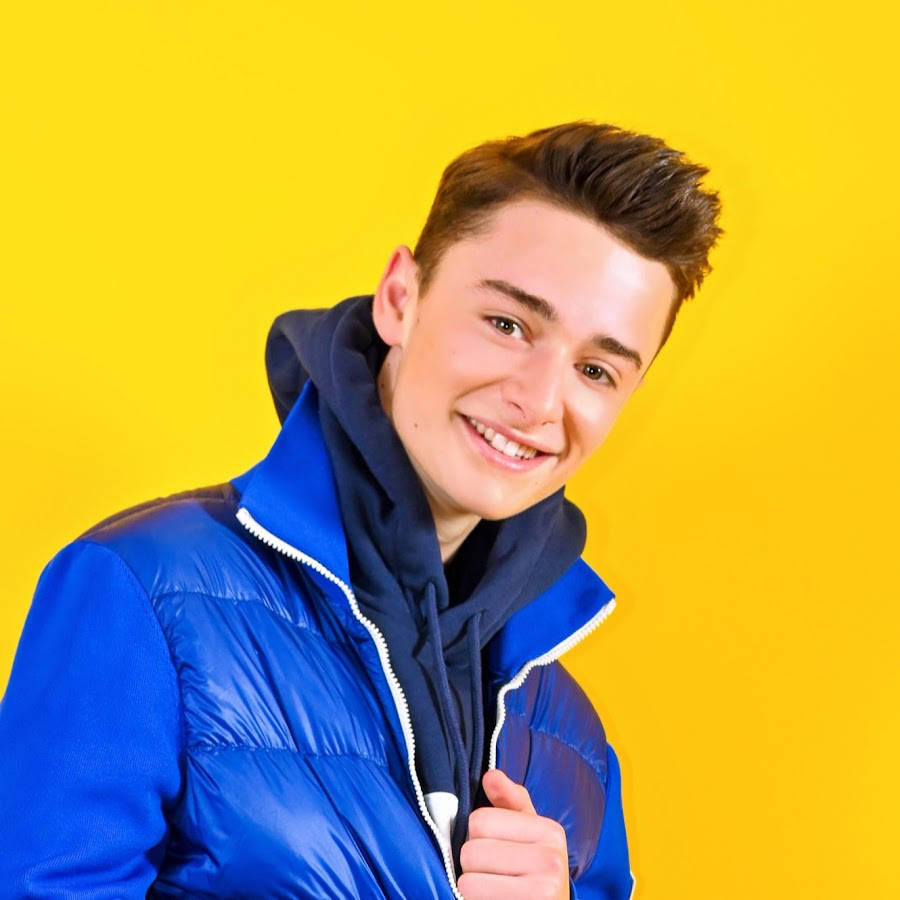 Noah Schnapp Posing Against Bright Yellow Backdrop