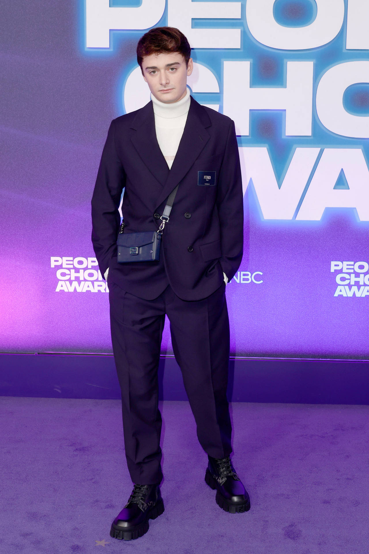 Noah Schnapp Turtleneck Under Dark Suit Background