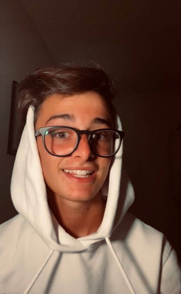 Noah Schnapp With Eyeglasses And White Hoodie Background