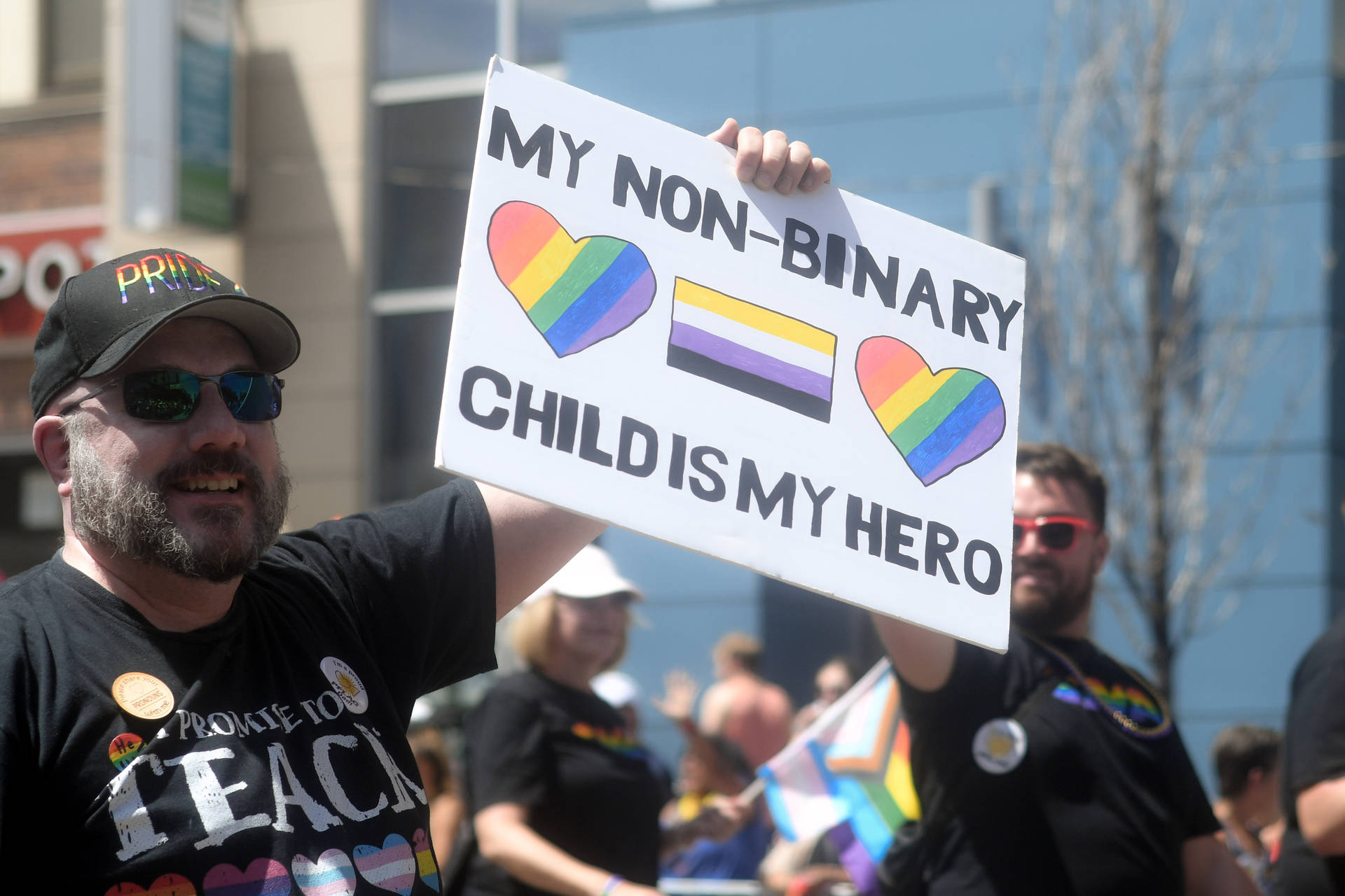 Non-binary Father In Protest Background