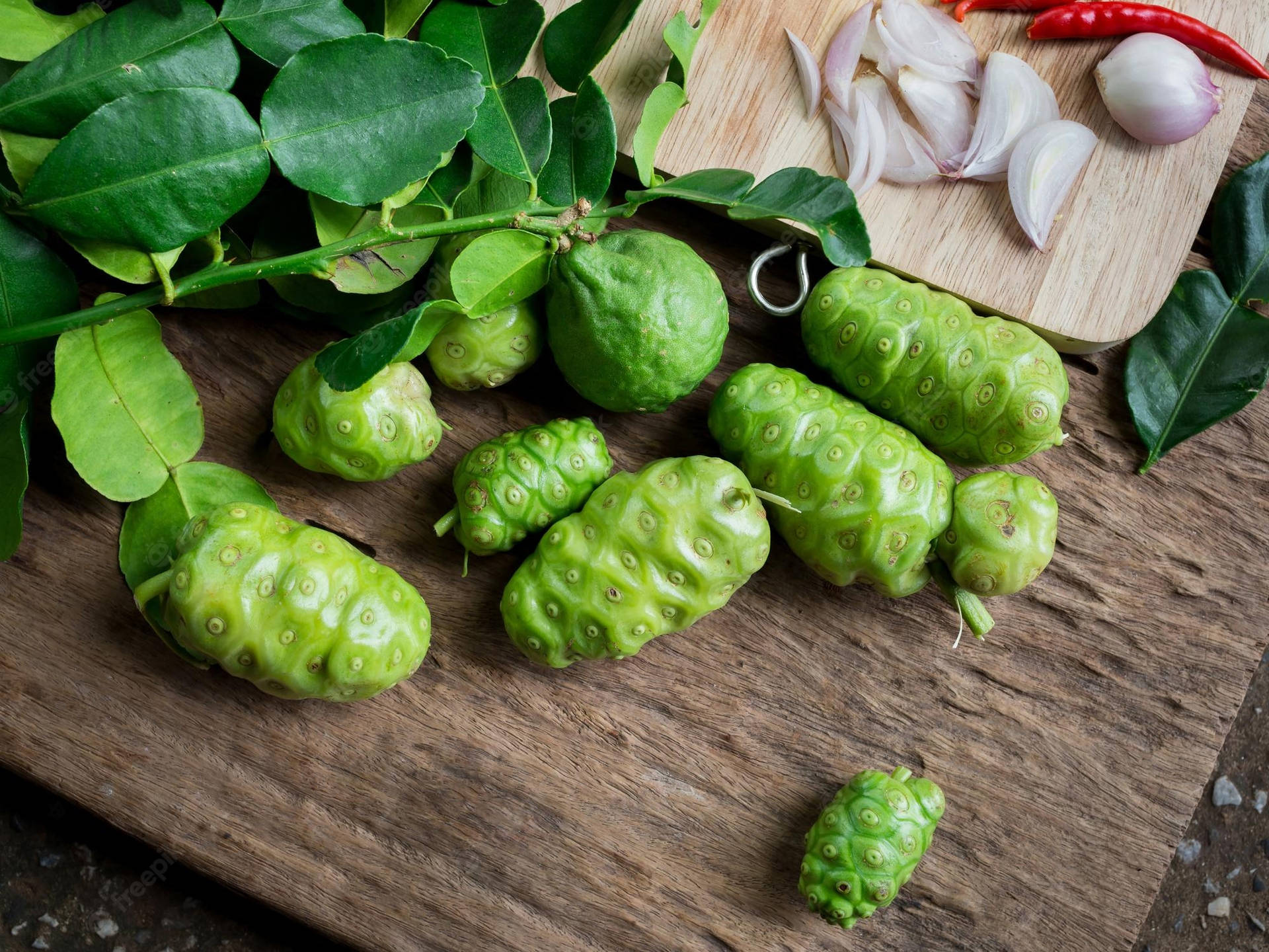 Noni Fruits On The Table Background