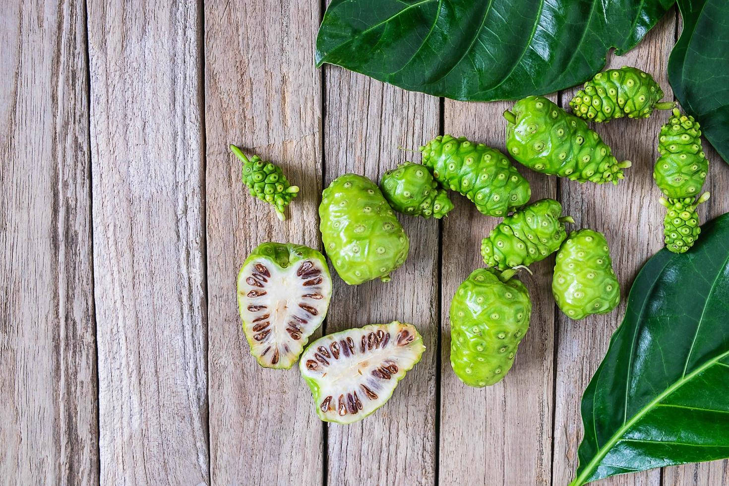 Noni Fruits On Wooden Table Background