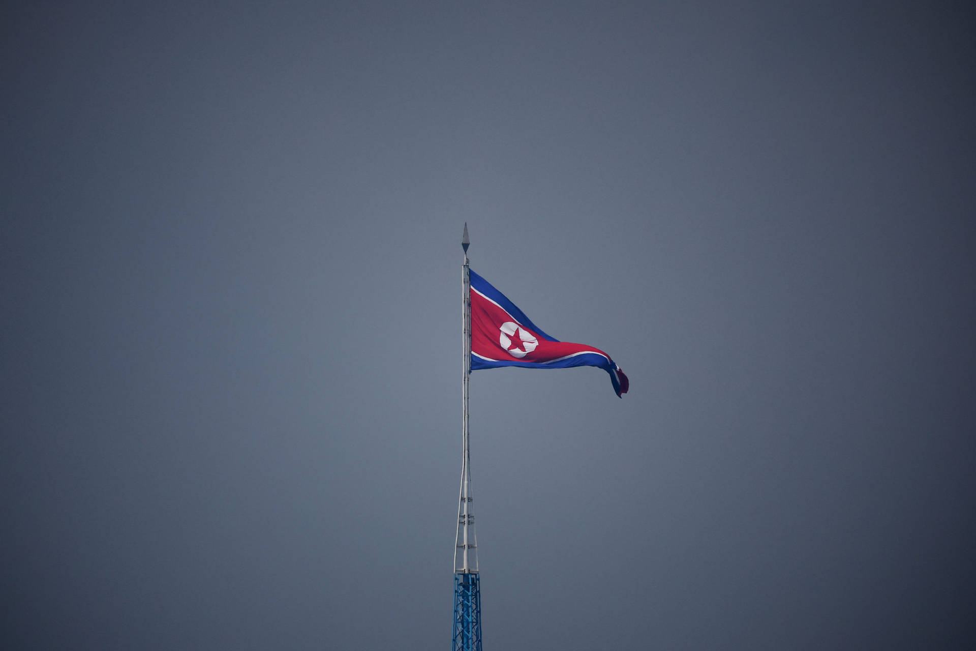 North Korea Flag On High Pole Background