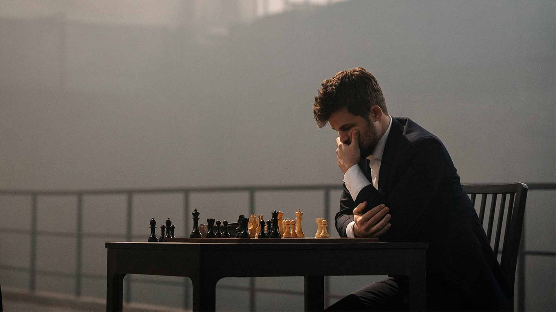 Norwegian Chess Grandmaster Magnus Carlsen Portraying An Expressive Pose During A Game. Background