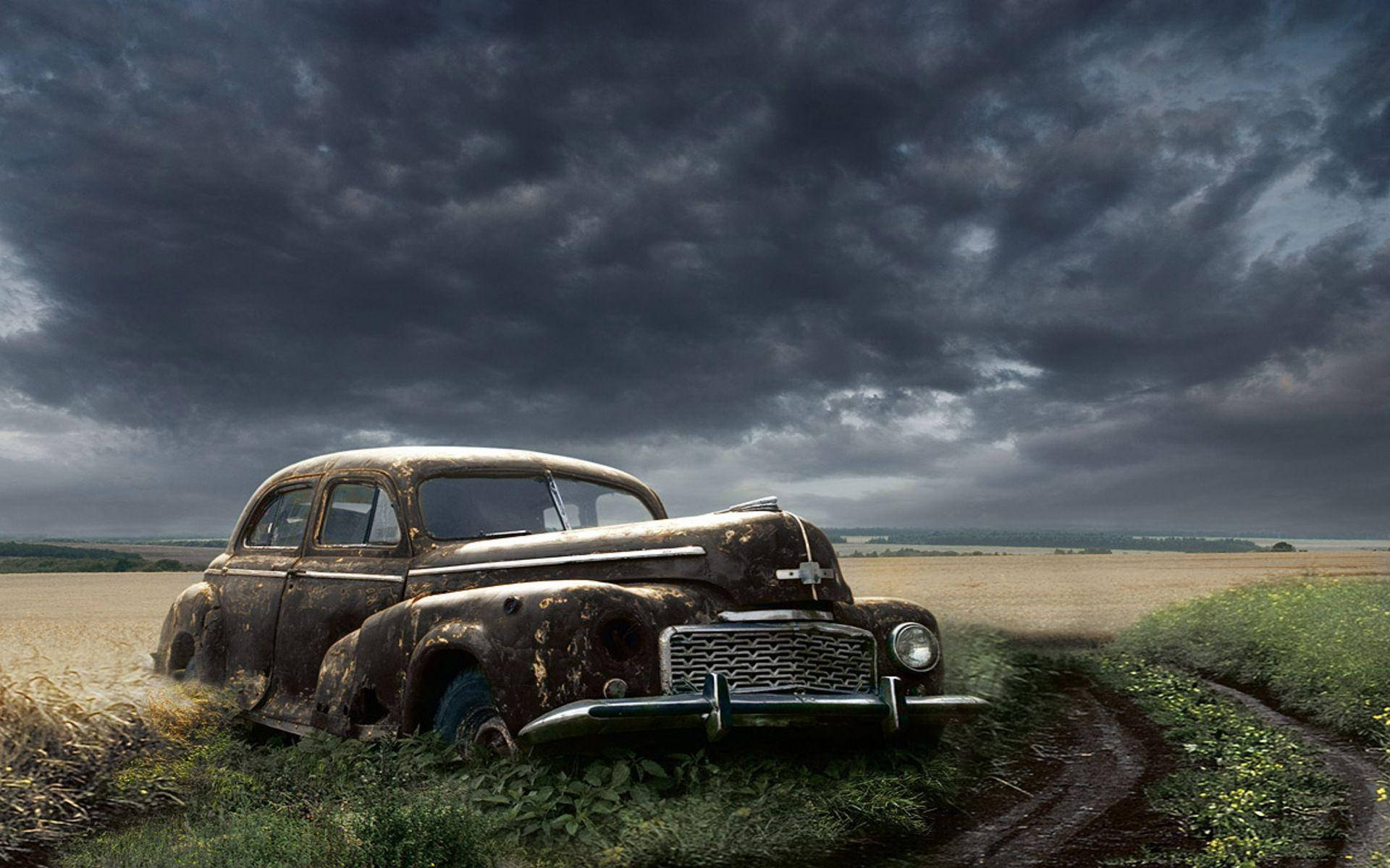 Nostalgic Remnant: Abandoned Old Car In Field Background