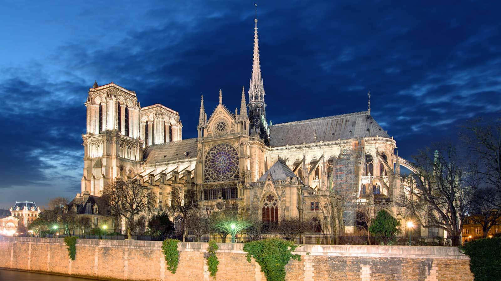 Notre Dame Cathedral Against Dark Blue Sky Background