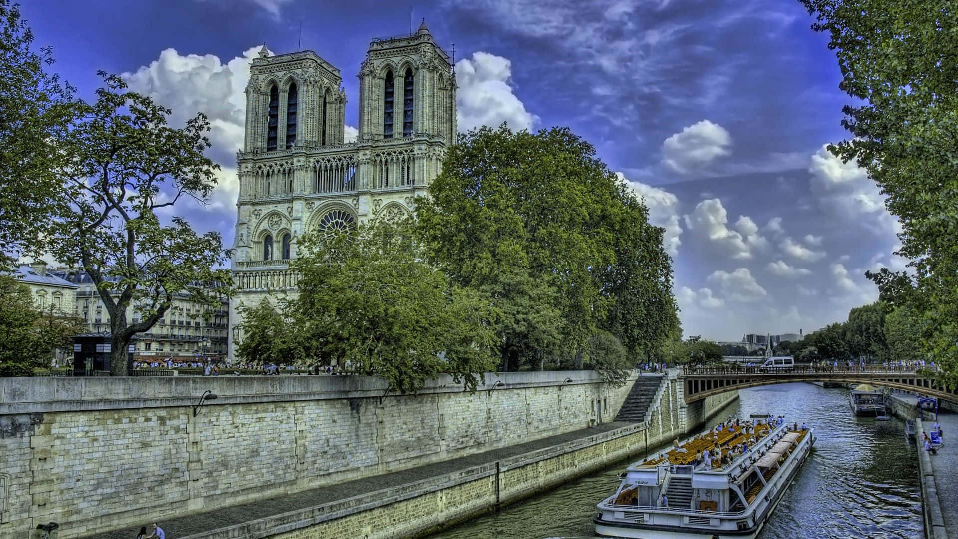 Notre Dame Cathedral With Boat Along The Seine Background