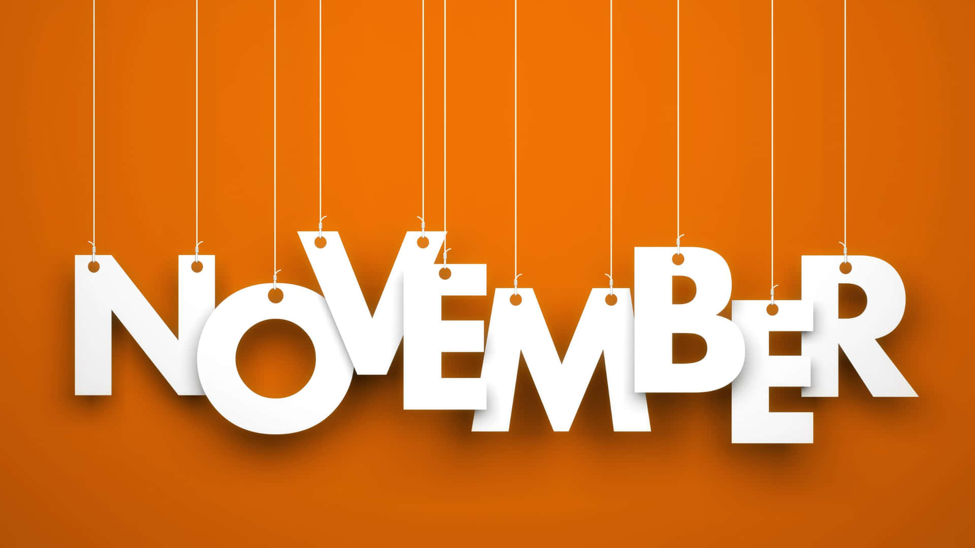November Word Hanging On Strings On Orange Background