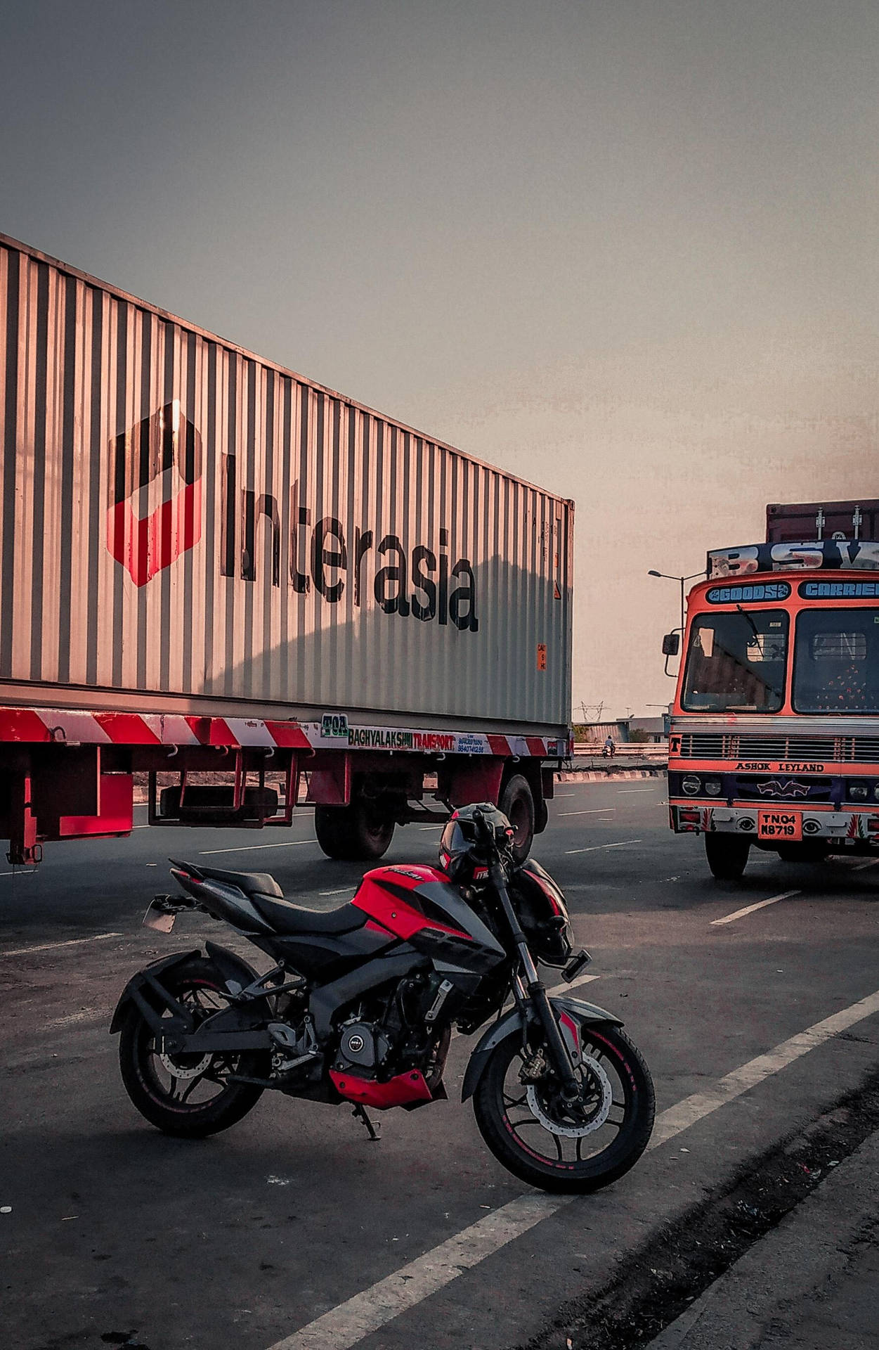 Ns 200 Black And Red Motorcycle Near Truck Background