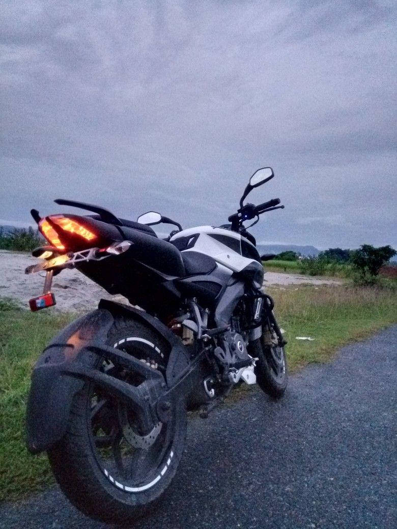 Ns 200 Motorcycle Under Overcast Sky Background