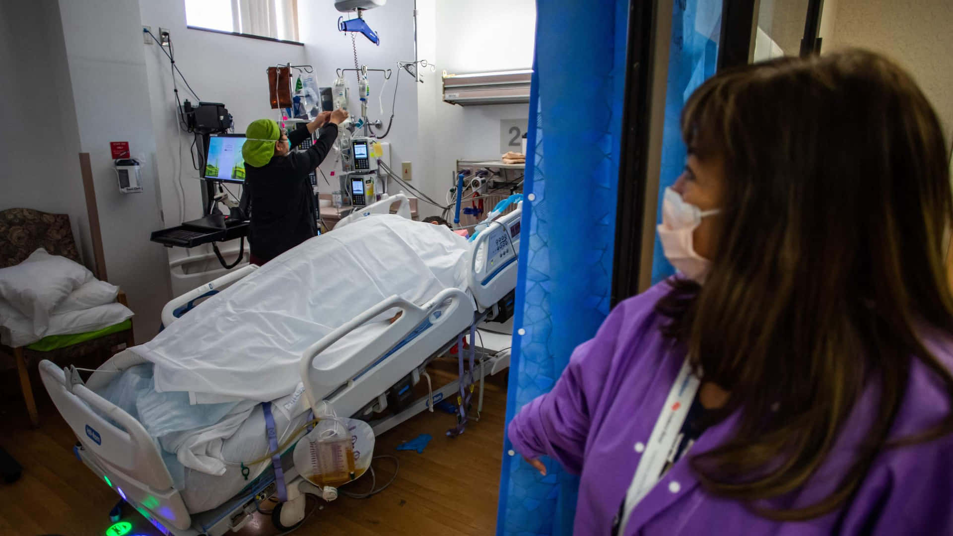 Nurse Looking Into Hospital Bed Background