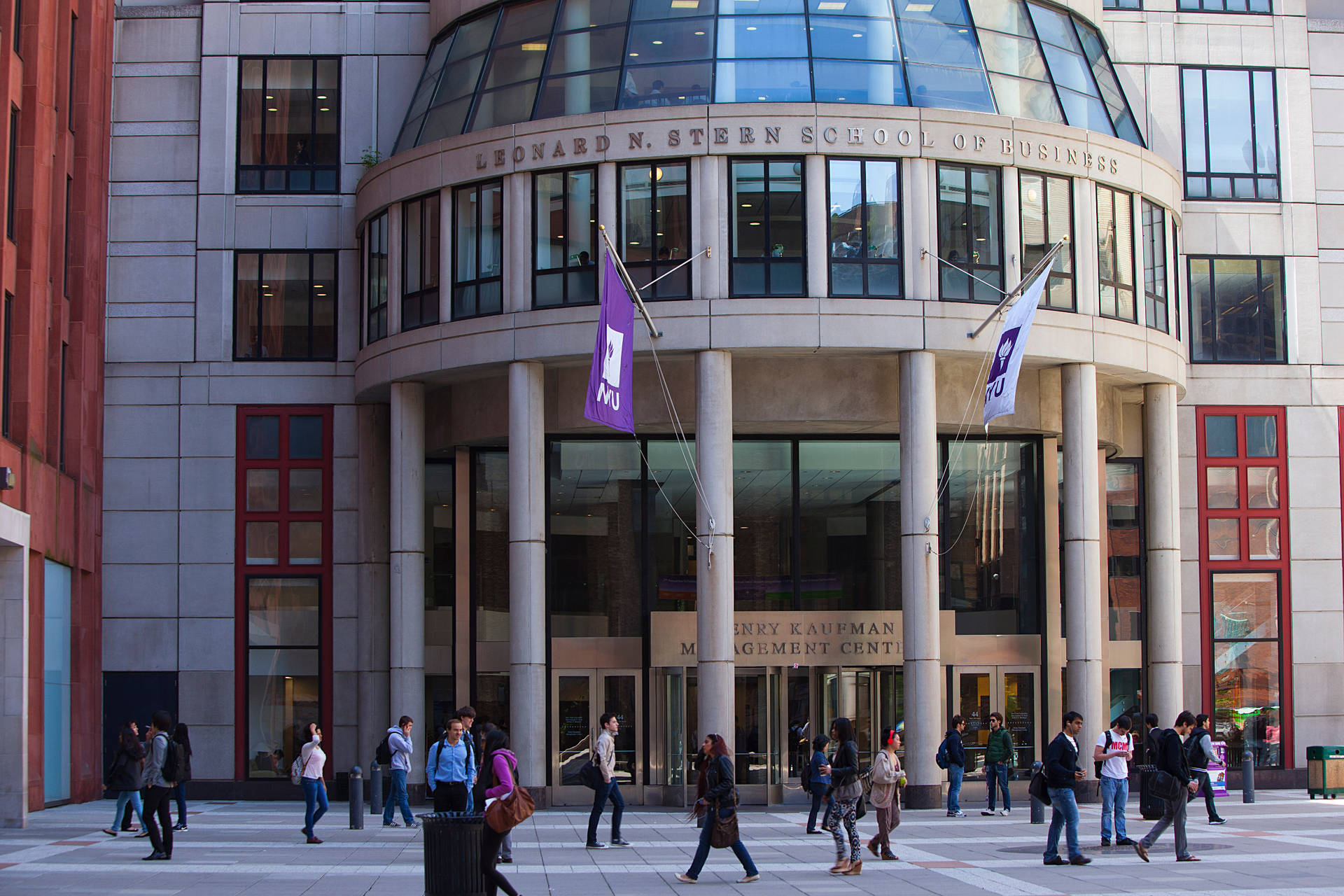 Nyu Business Students Walking On Campus Background