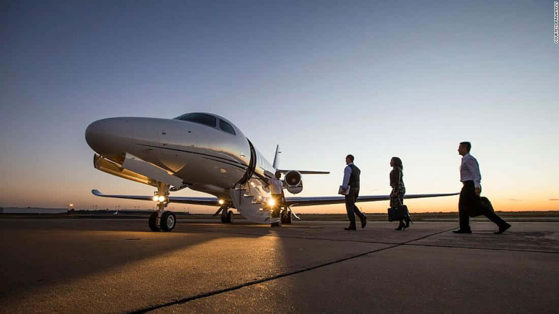 Officials Boarding A Luxurious Private Jet Background