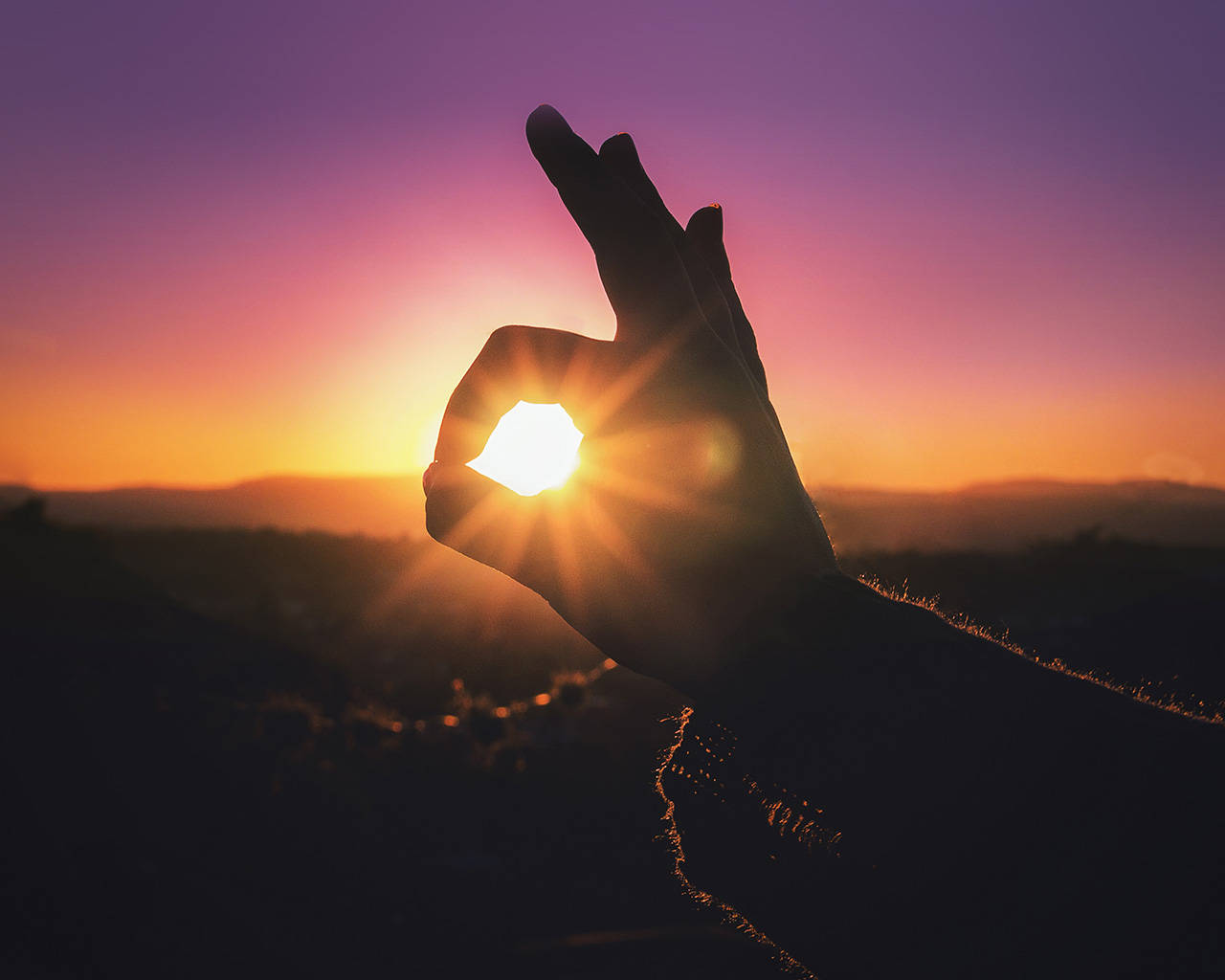 Okay Hand Sign With Sunset Background