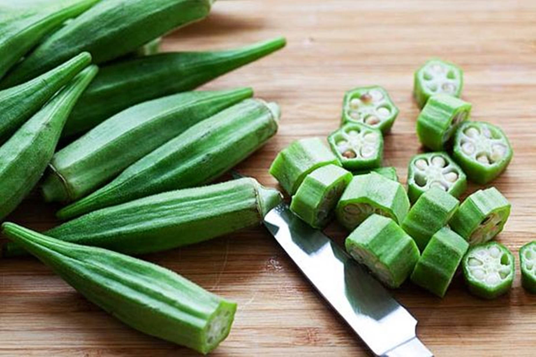 Okra And Knife On Chopping Board Background