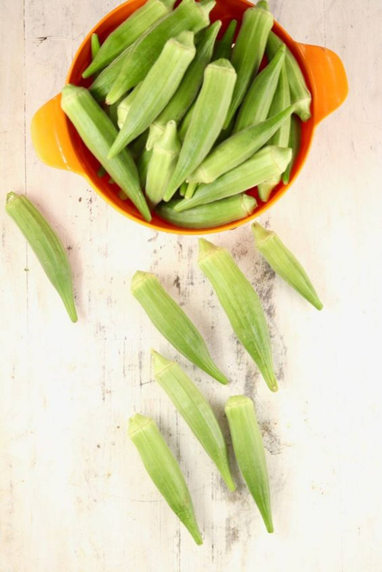 Okra Vegetables In Orange Bowl Background