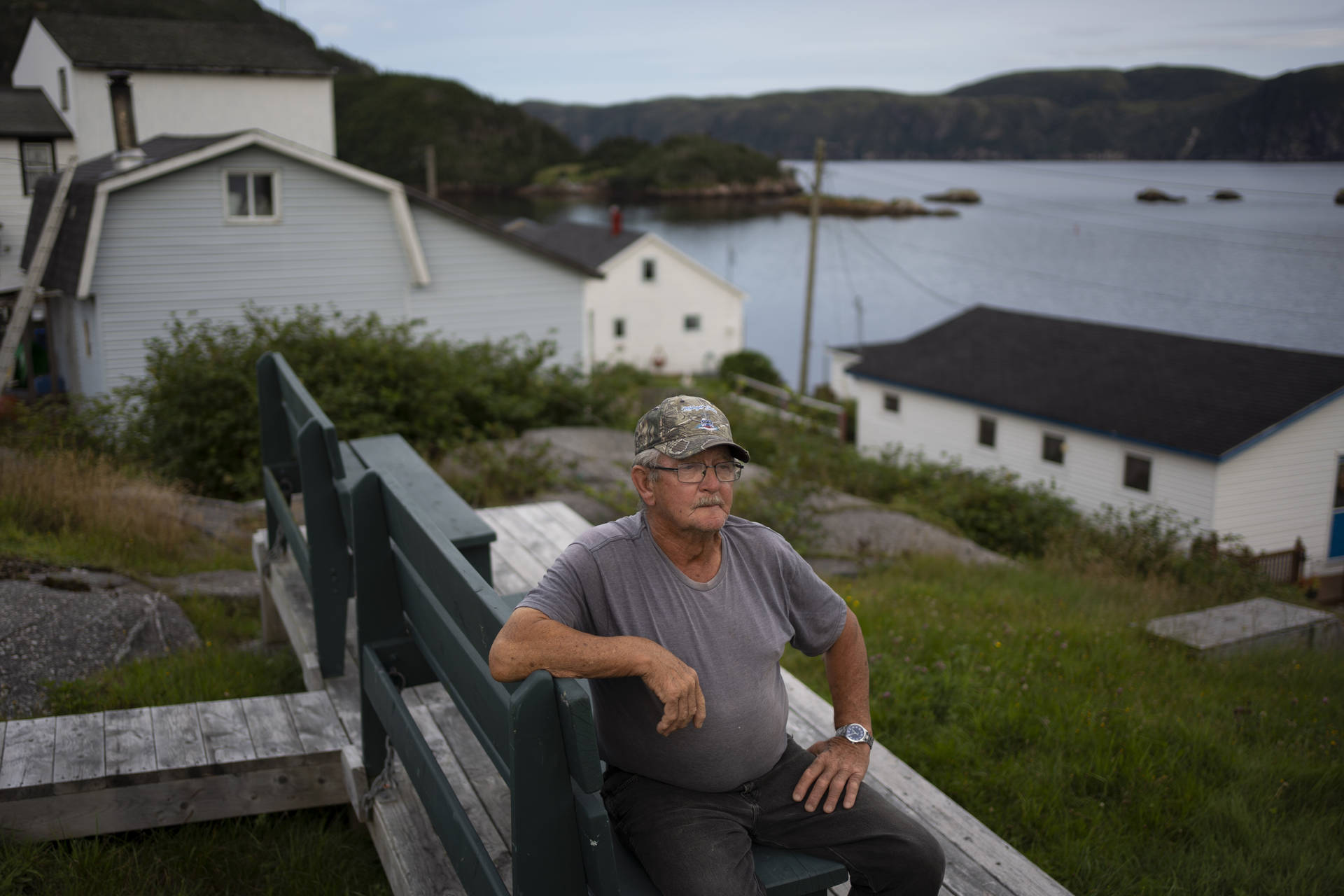 Old Man Looking At Newfoundland's Beauty Background