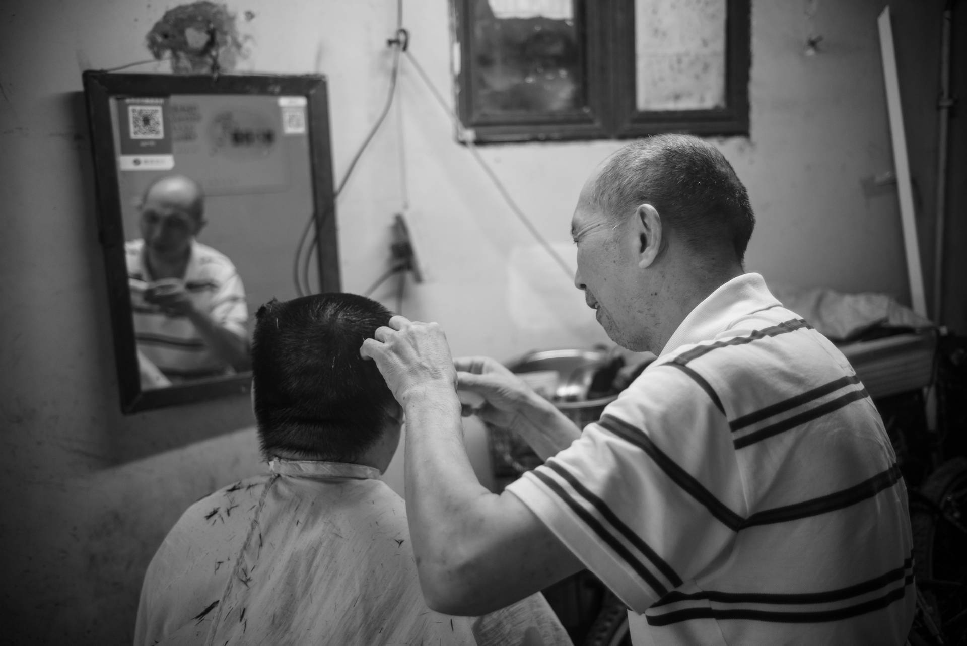 Old Man Performing Haircut Background