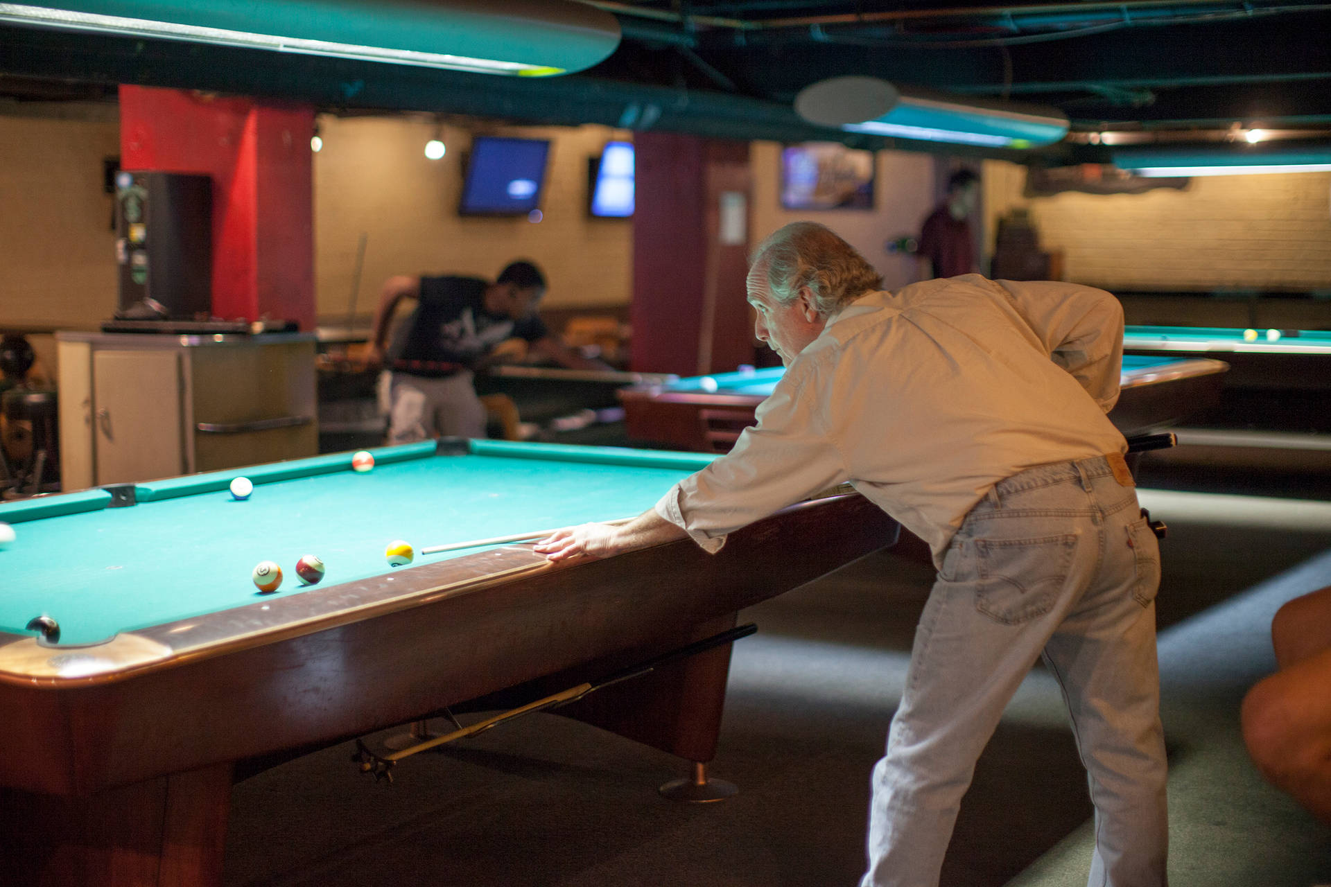 Old Man Playing Billiards At Bar