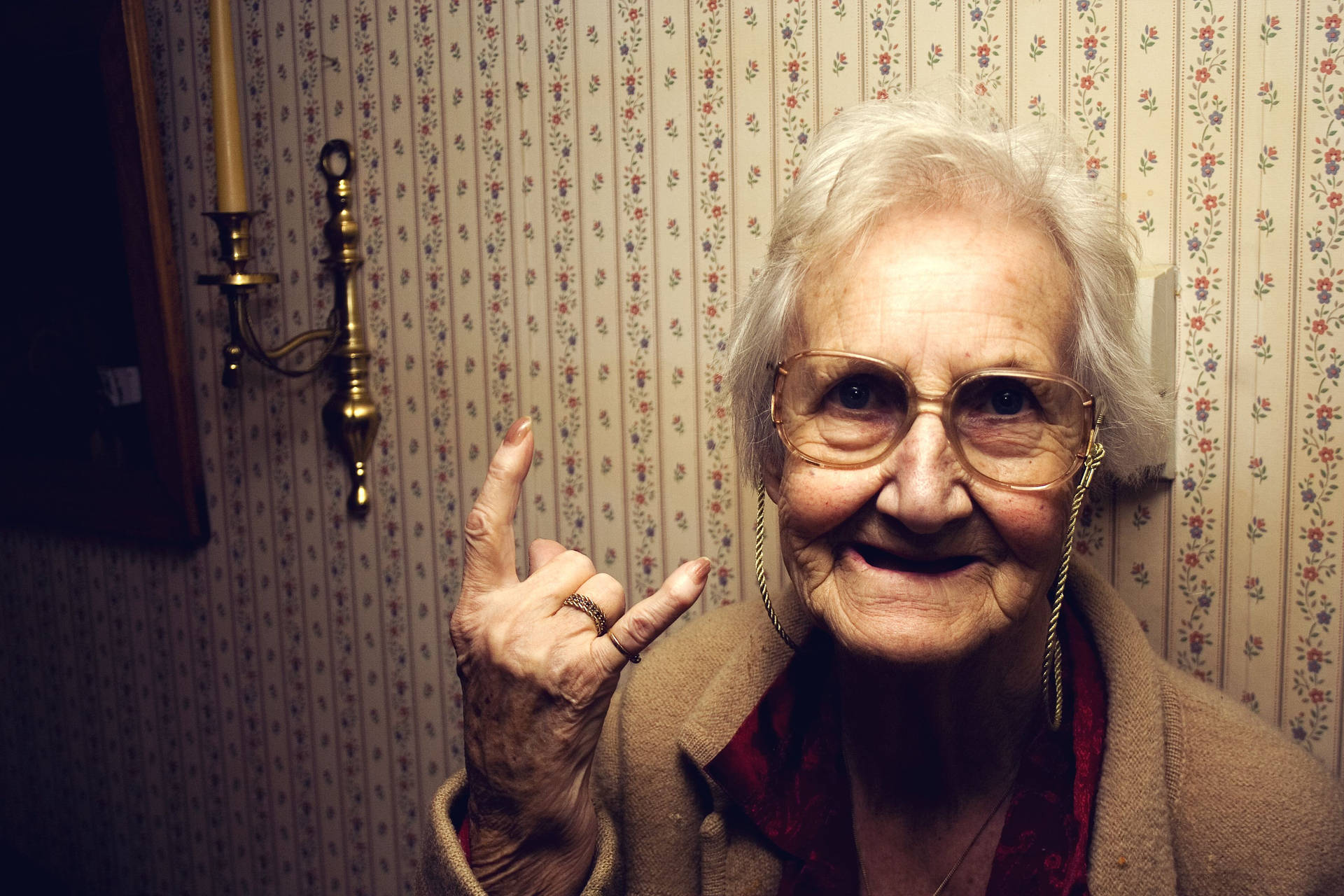 Old Woman Doing Rock And Roll Sign Background