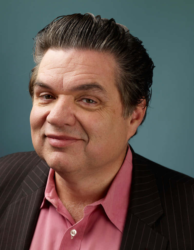 Oliver Platt Looks Intense In An Outdoor Setting Background
