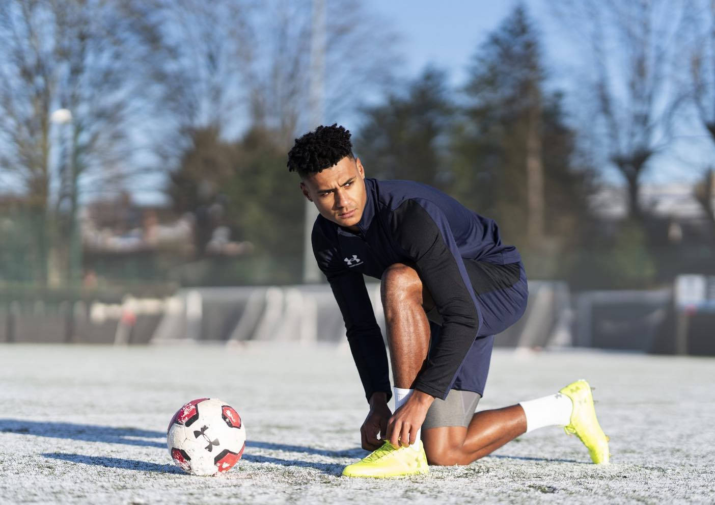 Ollie Watkins Fixing His Shoes Background