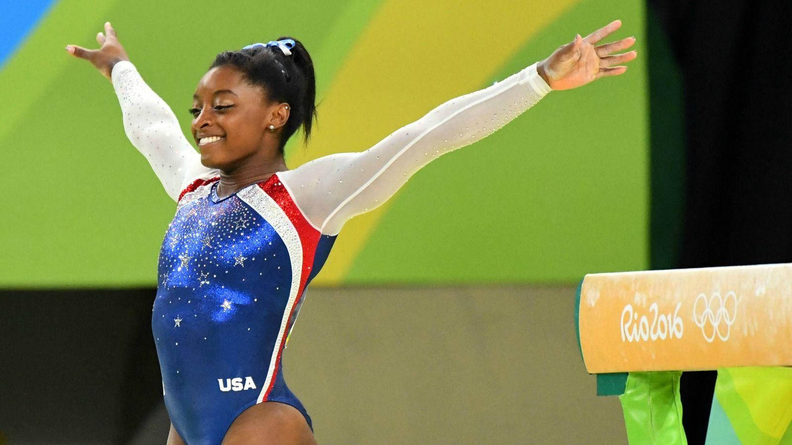 Olympian Simone Biles Arms Out Background