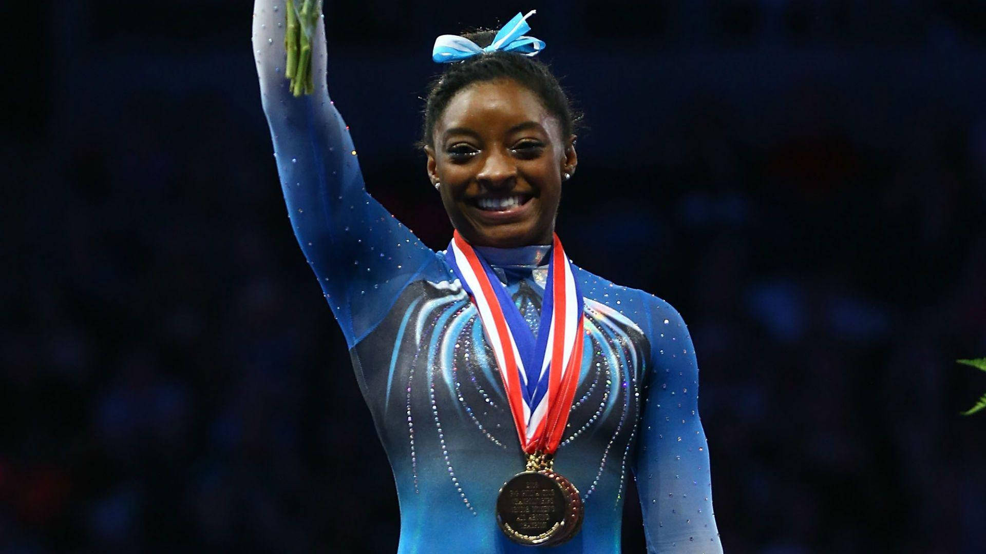 Olympic Gold Medal Gymnast Simone Biles Flawlessly Executing Her Routine Background