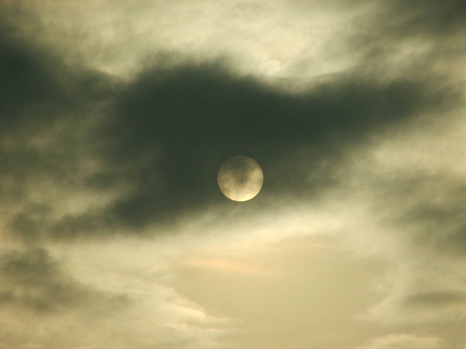 Ominous Moon Behind Dark Clouds