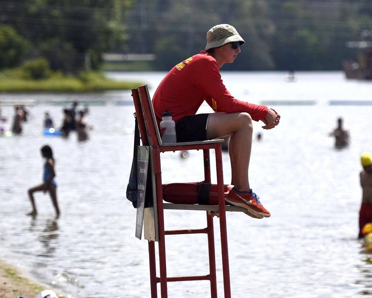 On Duty Lifeguard Sitting On Chair