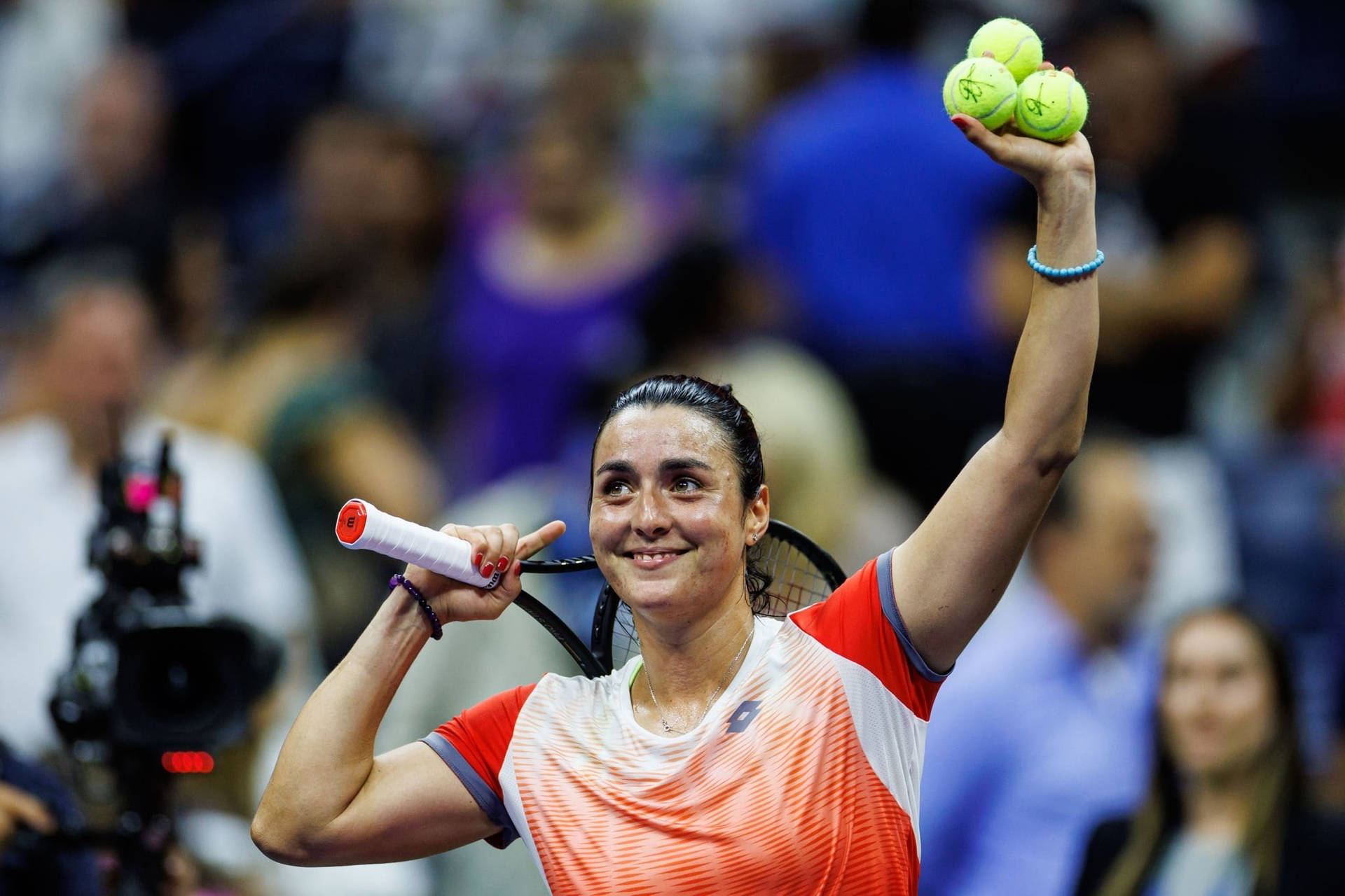 Ons Jabeur, A Tunisian Professional Tennis Player, Holding Three Tennis Balls In The Court. Background