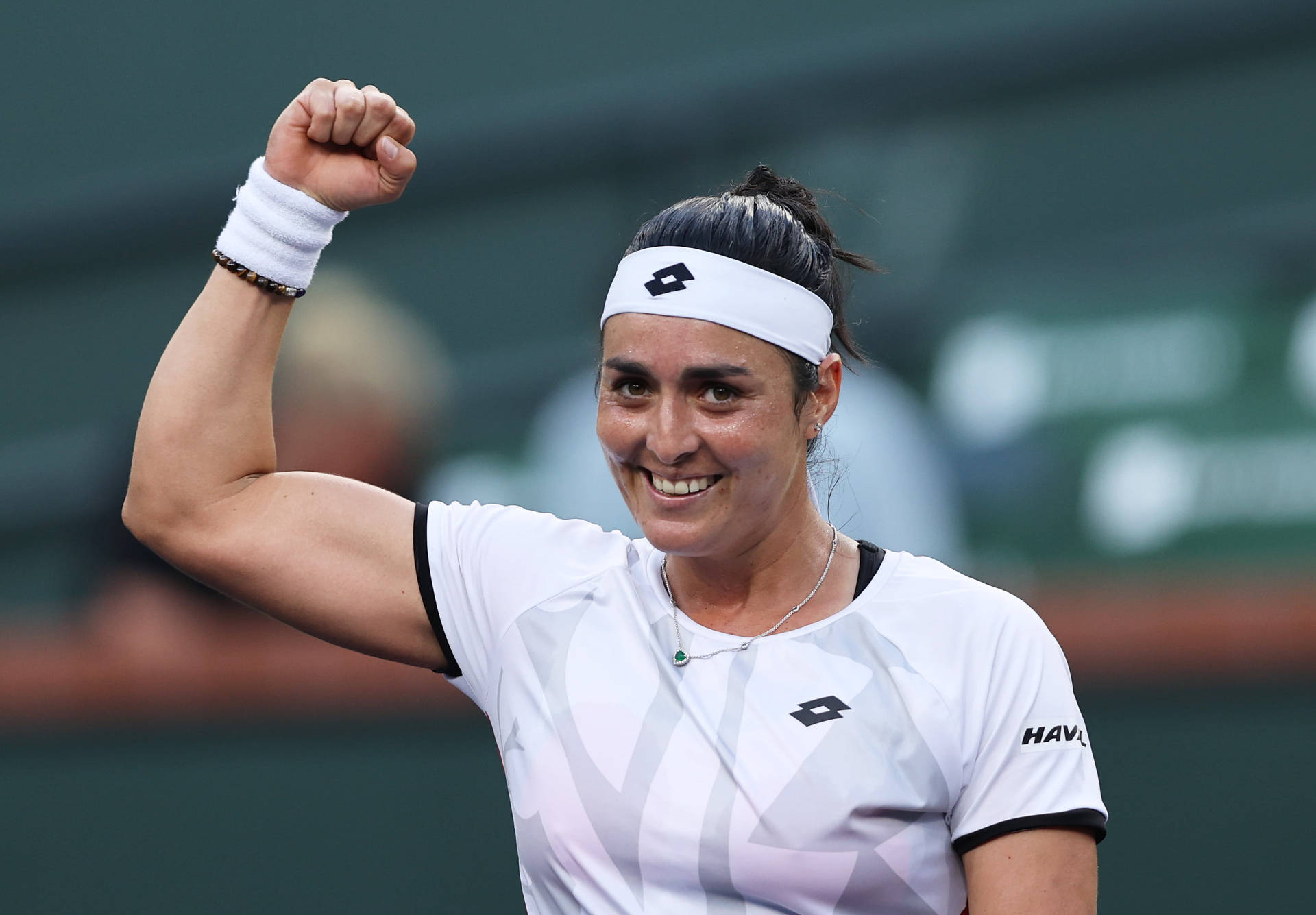 Ons Jabeur Celebrates Victory On The Court Background