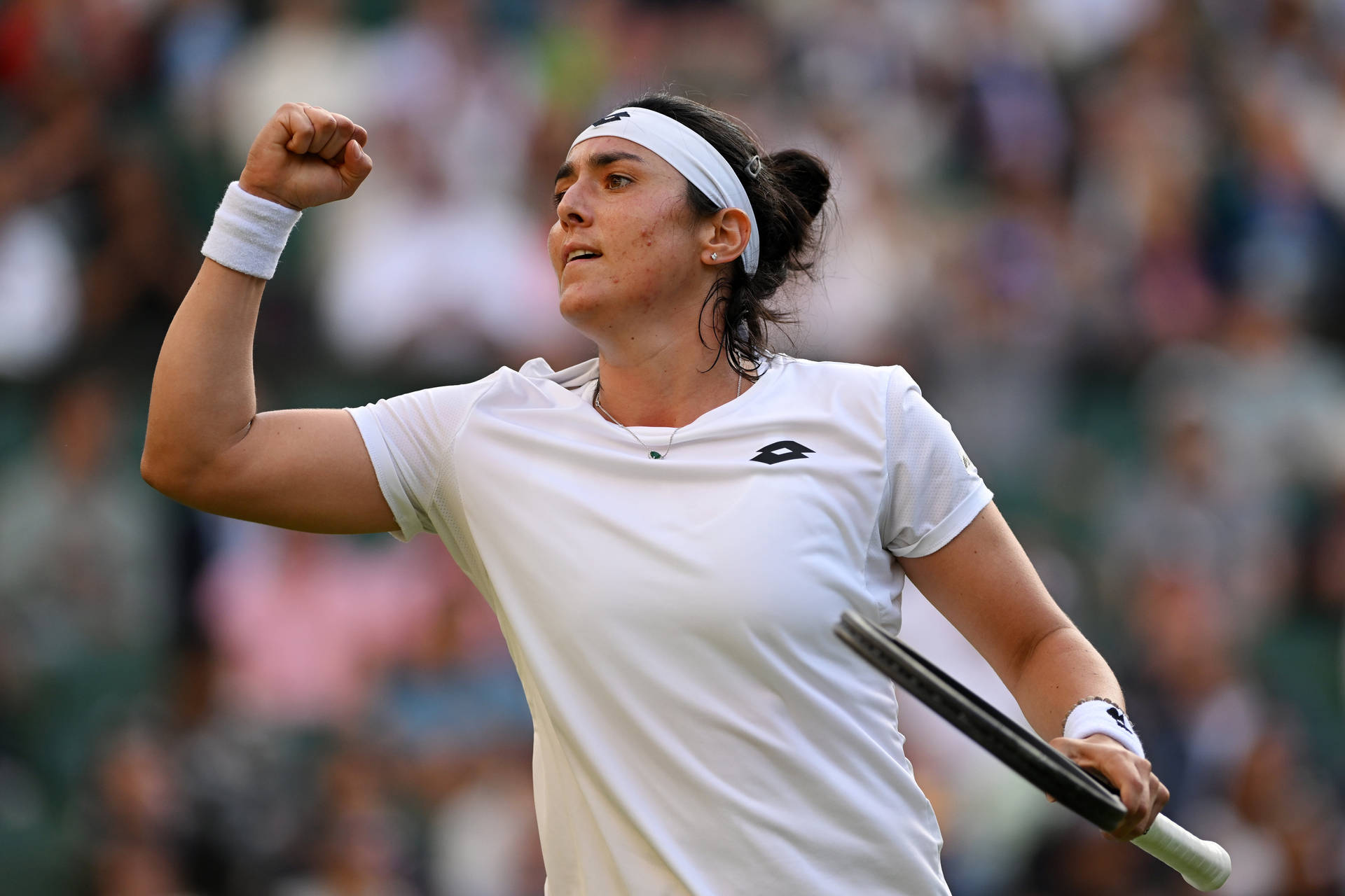 Ons Jabeur Fist Raised Holding Racket Background