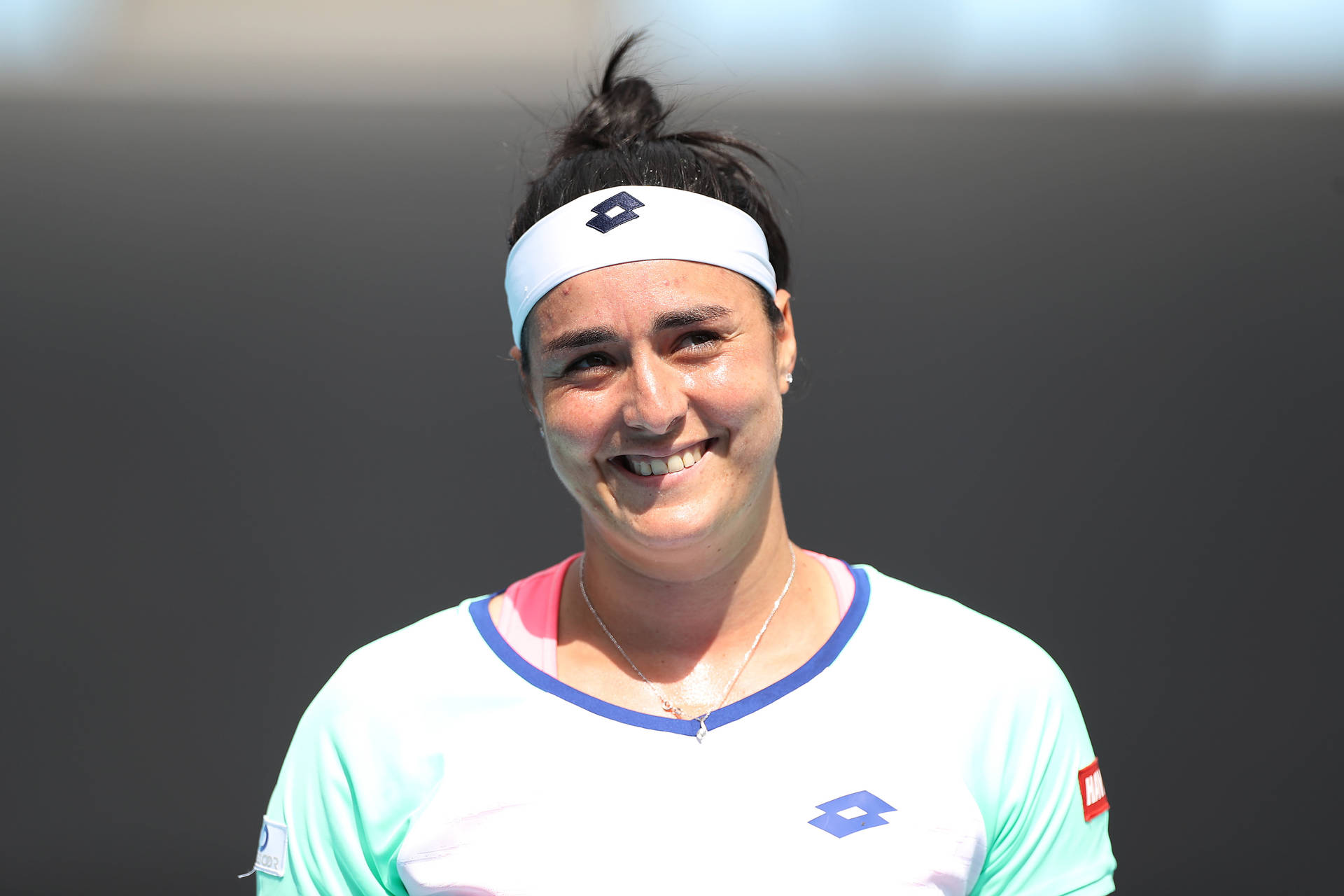 Ons Jabeur, The Successful Tunisian Tennis Star, Lights Up The Court With Her Radiant Smile Background