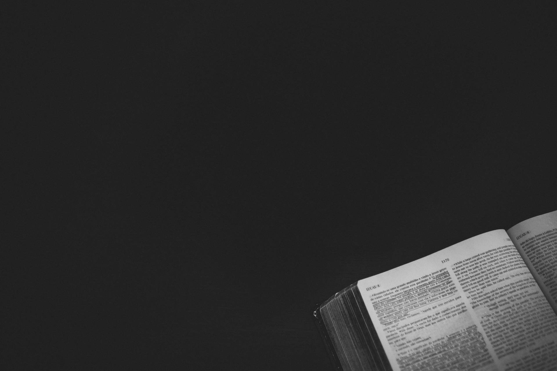 Open Bible On A Black Background Background