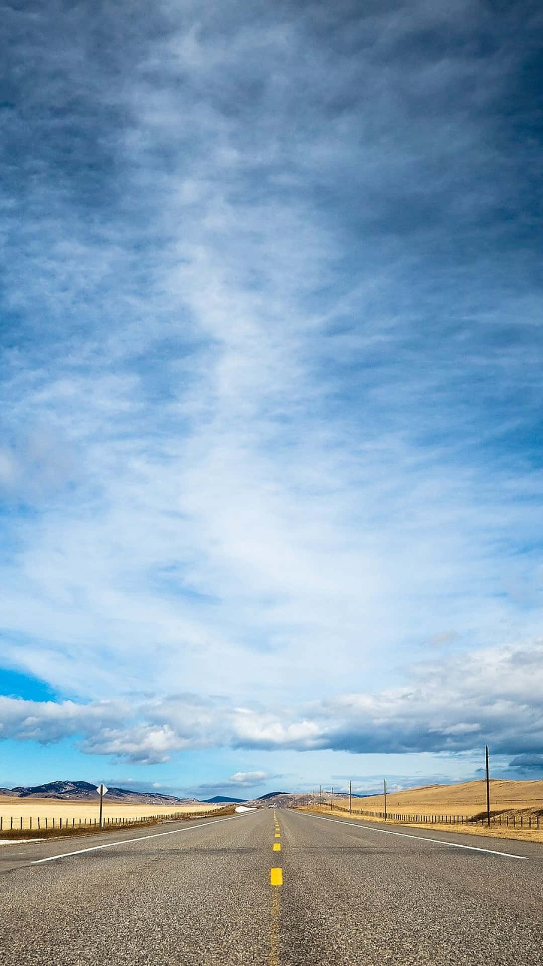 Open Road Under Expansive Sky Background