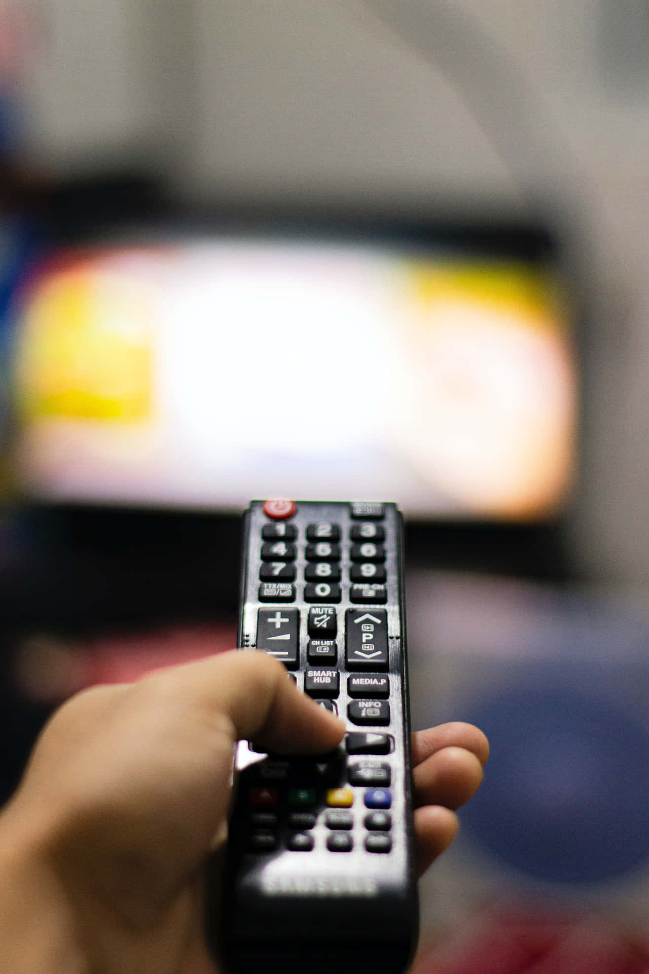 Operating A Tv Using Remote Control Background