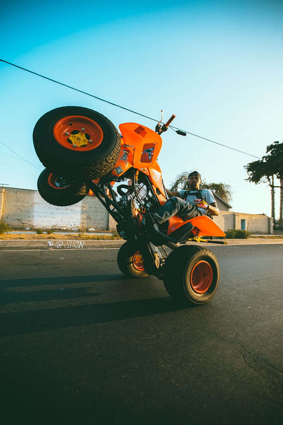 Orange A T V Wheelie Stunt Background