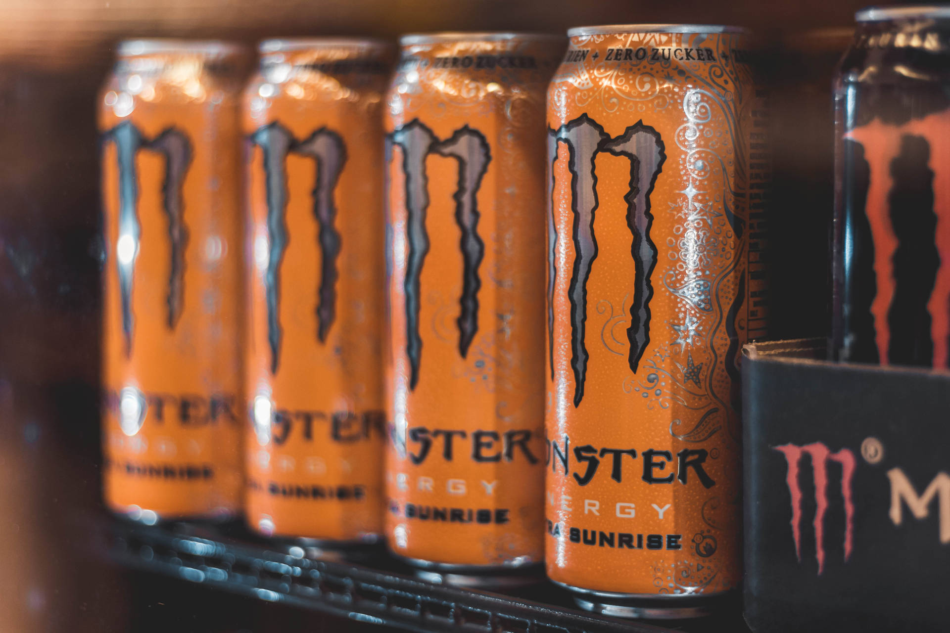 Orange And Black Monster Energy Cans Background
