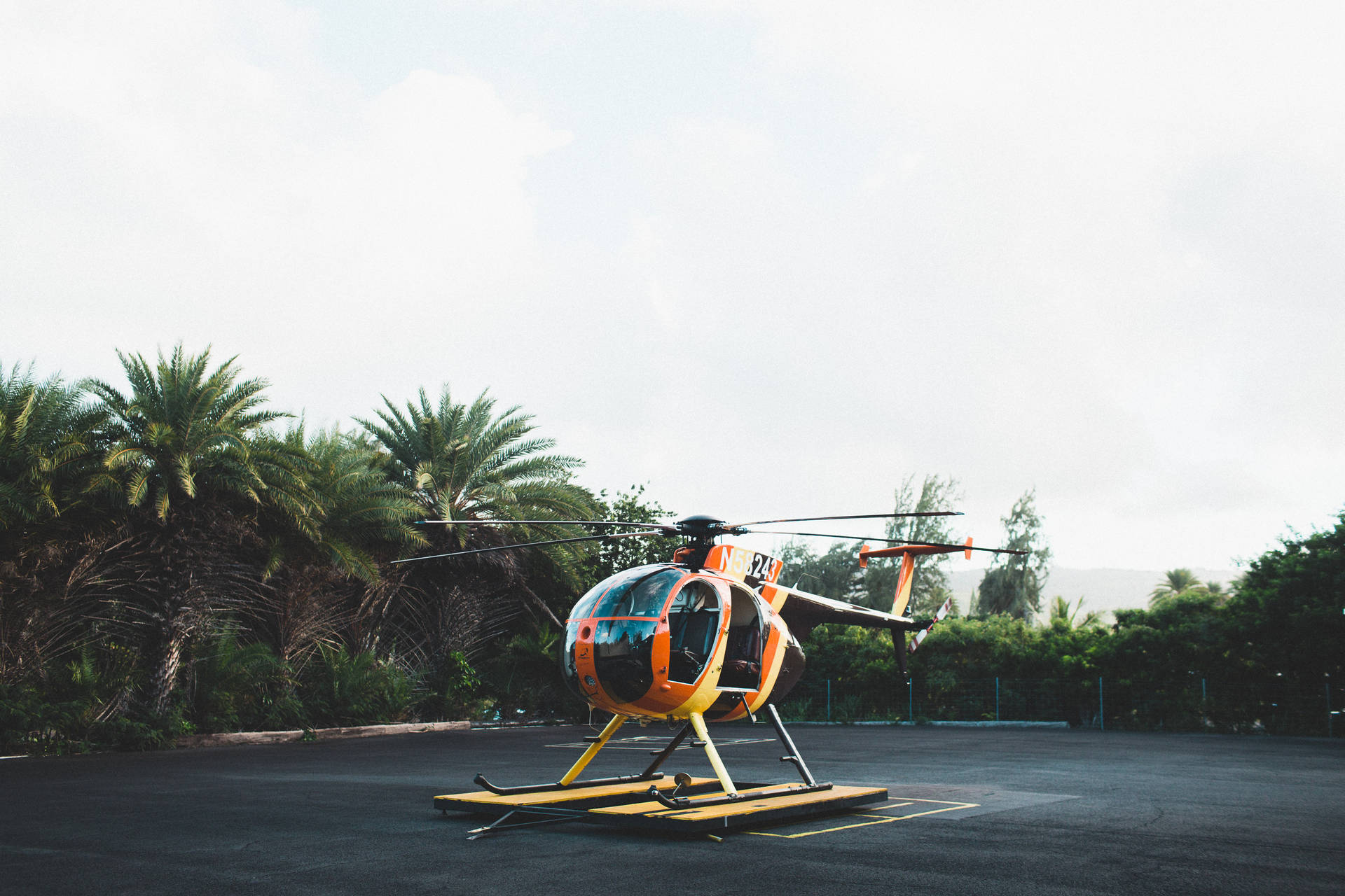 Orange And Yellow Helicopter On Ground Background